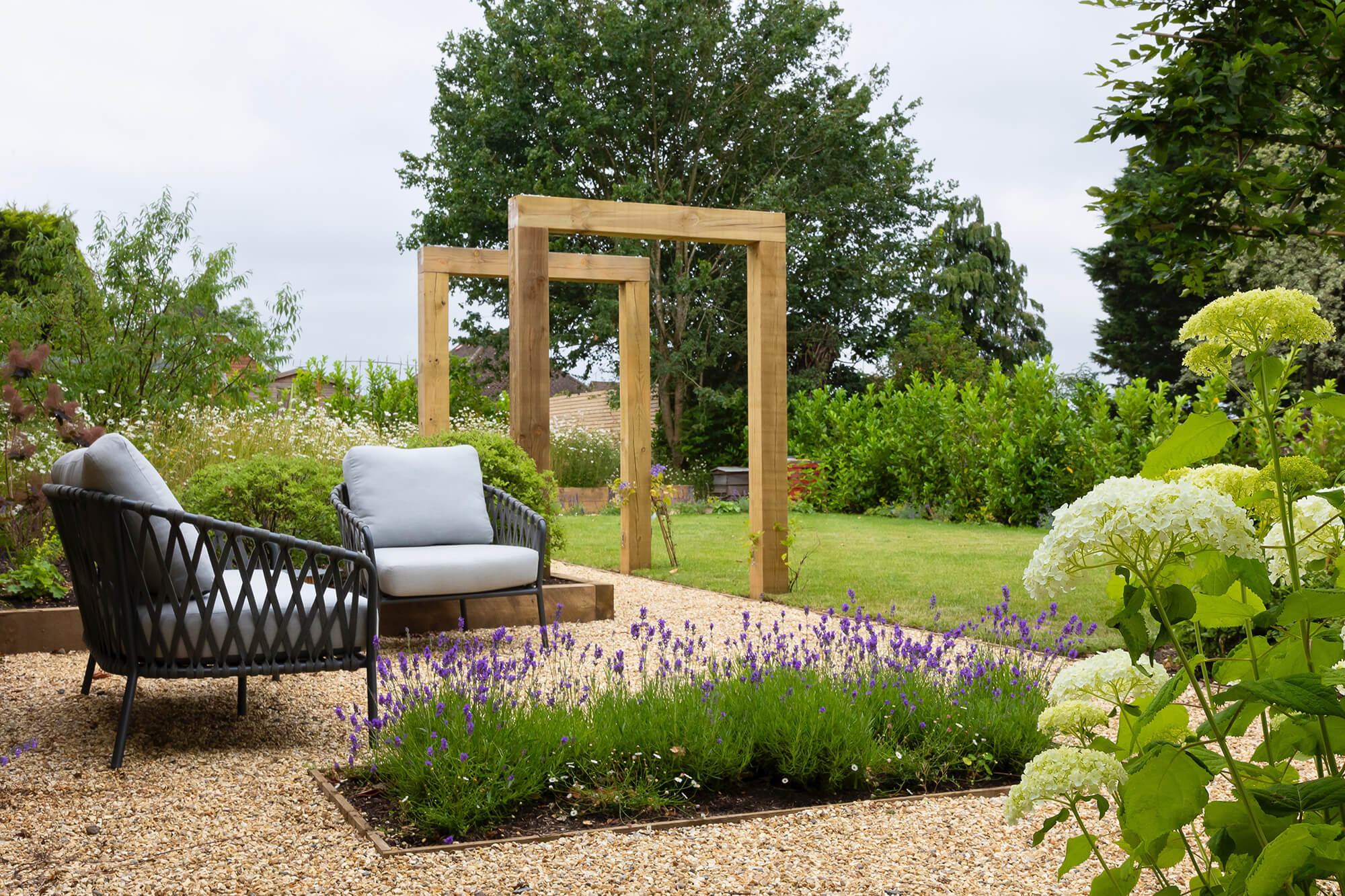 Garden seating area surrounded by flowers.