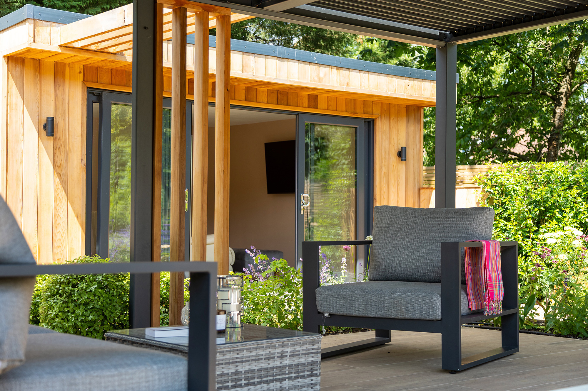 A garden room with an outdoor seating area.